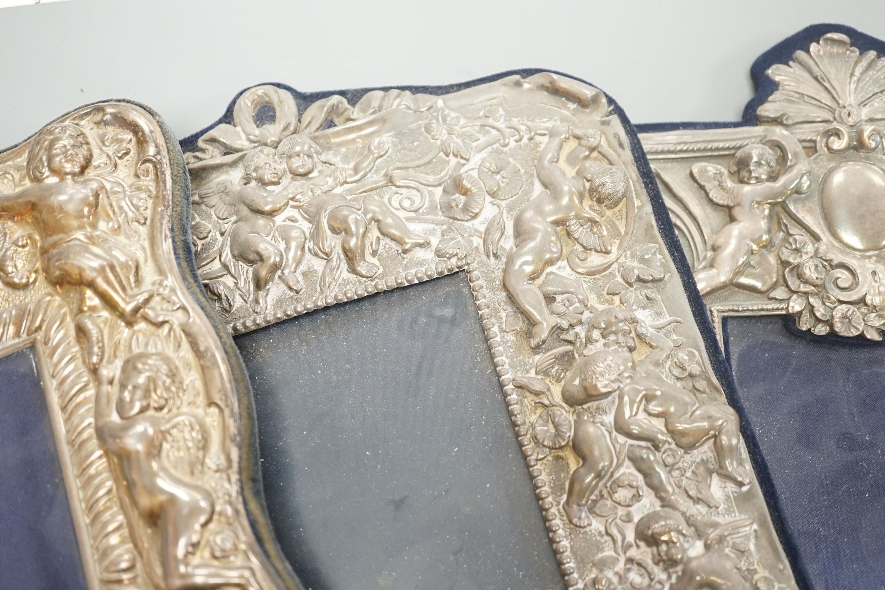 Three assorted ornate modern silver mounted photograph frames, largest overall 33.5cm.